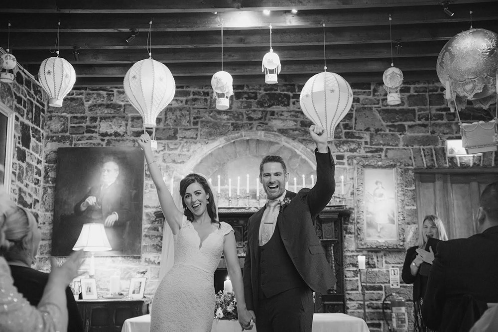 Bride and groom fist pumping the air after being legally married by Humanist Wedding Celebrant Ealish Whillock in Ballyseede Castle Tralee